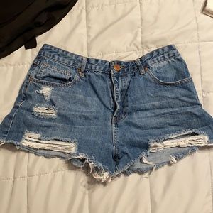 blue jean shorts, with rips.